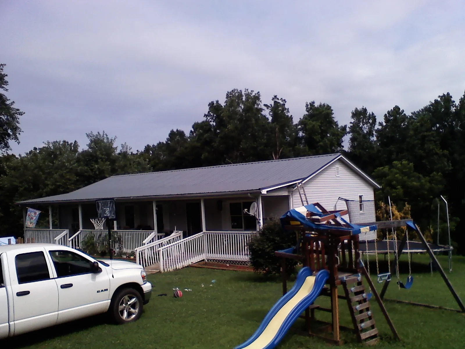 Dark metal roof on a country home with a full length front porch in Chatsworth